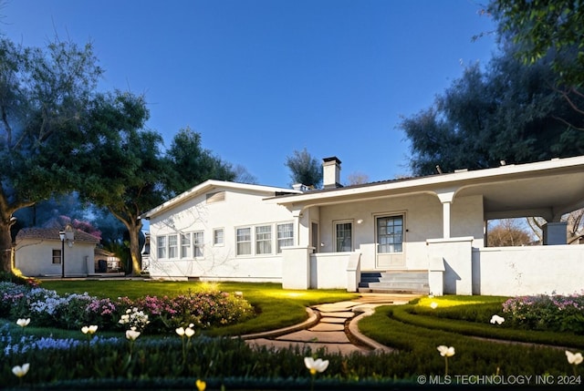 view of front of home featuring covered porch and a front yard