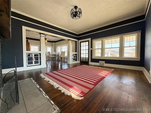 bedroom with dark hardwood / wood-style flooring, ornamental molding, and a textured ceiling