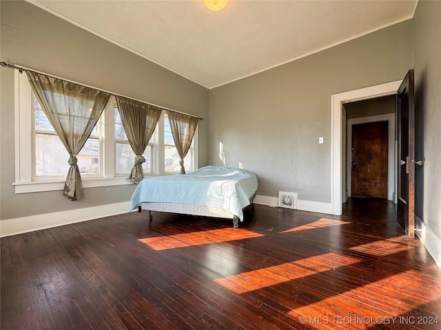 bedroom with wood-type flooring and lofted ceiling