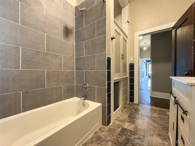 bathroom featuring vanity and tiled shower / bath combo