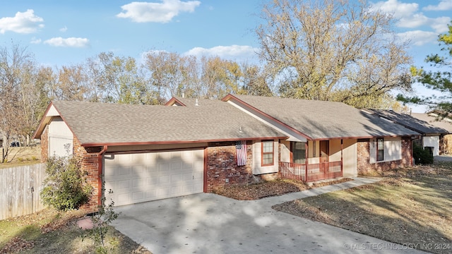 view of front of home with covered porch and a garage