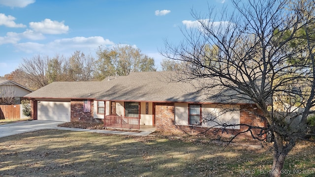 ranch-style home with a garage and a front lawn