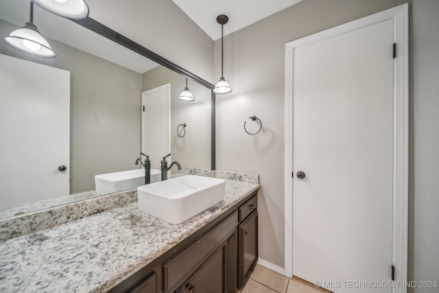 bathroom featuring tile patterned flooring and vanity