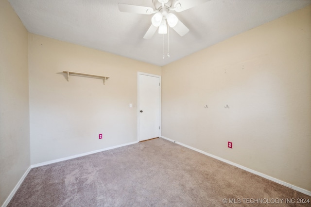 spare room with light carpet and ceiling fan