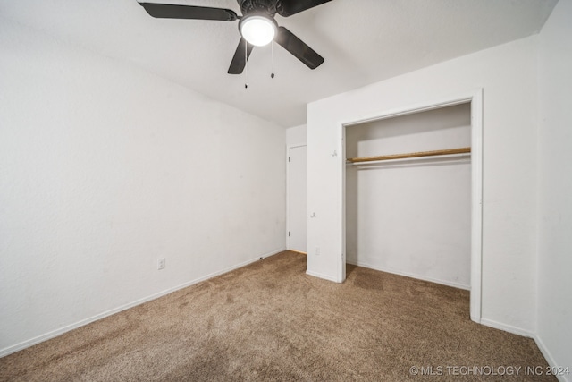 unfurnished bedroom featuring ceiling fan, a closet, and carpet floors