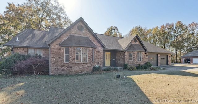 view of front of property with a front lawn and a garage