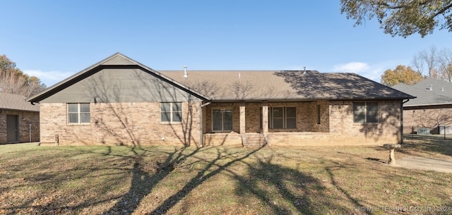 back of house featuring a lawn