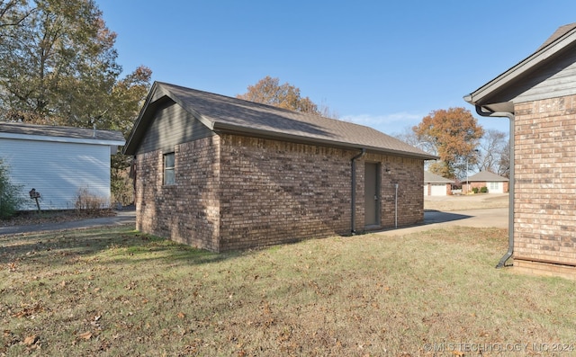 view of side of home featuring a yard