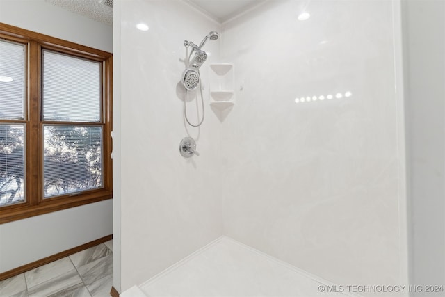 bathroom featuring a textured ceiling and walk in shower