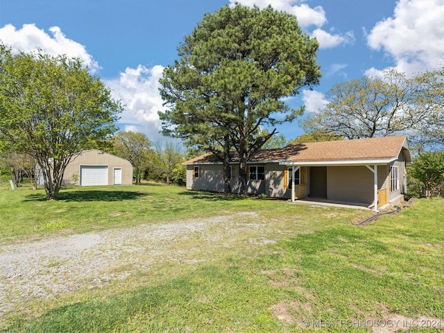 view of front of house with a front lawn, an outdoor structure, and a garage