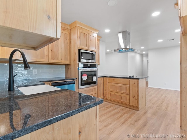 kitchen featuring light brown cabinets, light hardwood / wood-style flooring, island range hood, kitchen peninsula, and stainless steel appliances