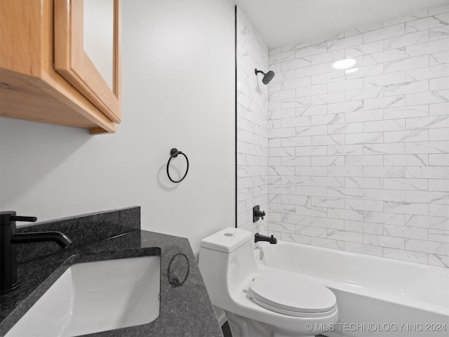 full bathroom with toilet, tiled shower / bath, and sink