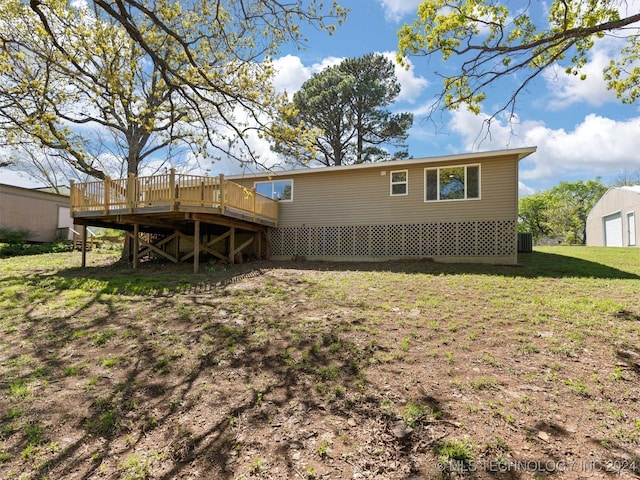 back of house featuring a yard and a deck