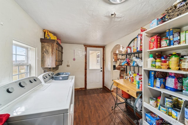 washroom with cabinets, washing machine and dryer, dark wood-type flooring, and a textured ceiling