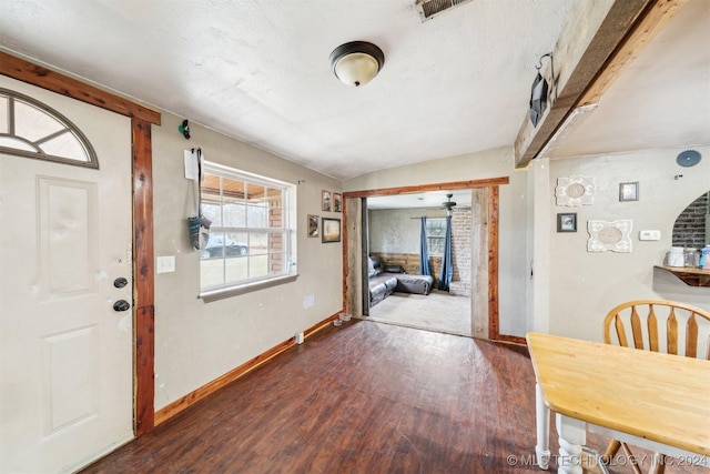 foyer featuring dark hardwood / wood-style flooring and lofted ceiling