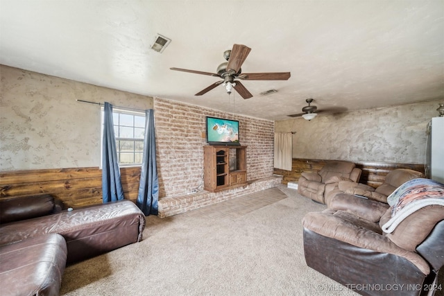 carpeted living room with ceiling fan