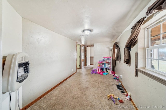 playroom featuring carpet flooring and heating unit