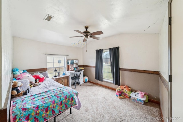 carpeted bedroom featuring multiple windows, lofted ceiling, and ceiling fan