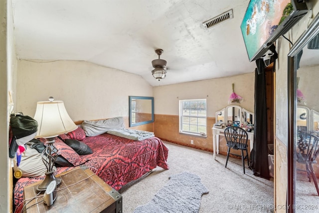 carpeted bedroom featuring ceiling fan and vaulted ceiling