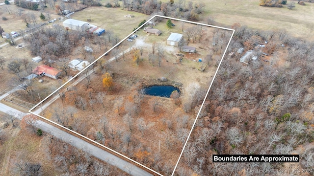 birds eye view of property with a rural view