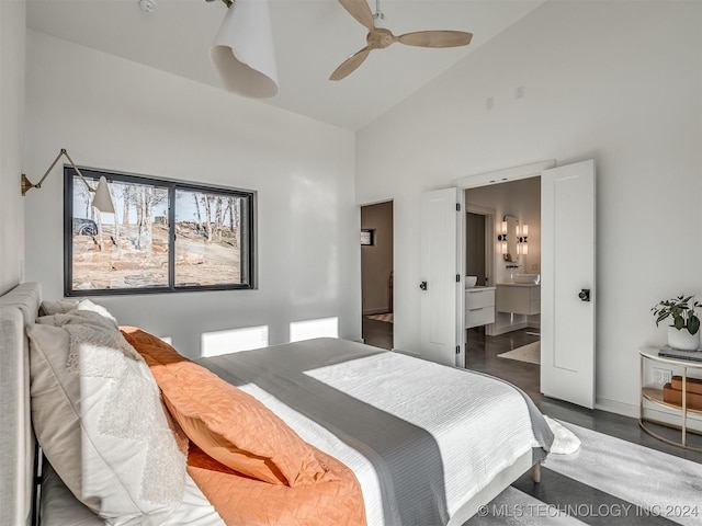 bedroom featuring ensuite bathroom, high vaulted ceiling, ceiling fan, and dark wood-type flooring