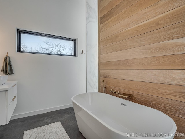 bathroom featuring a washtub and vanity