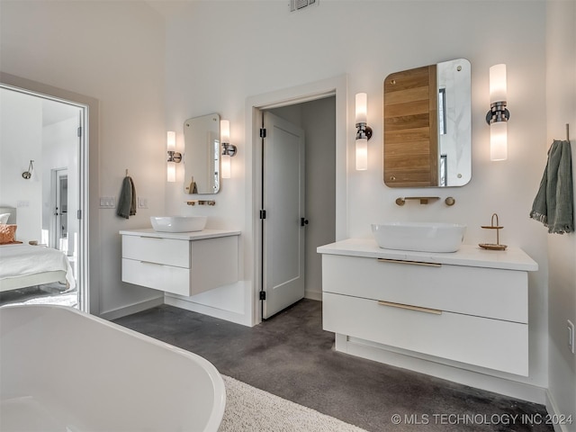 bathroom featuring a washtub and vanity