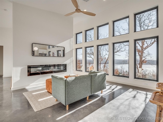 living room featuring a high ceiling and ceiling fan