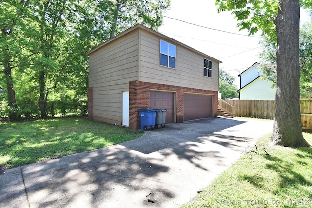 view of side of home featuring a yard and a garage