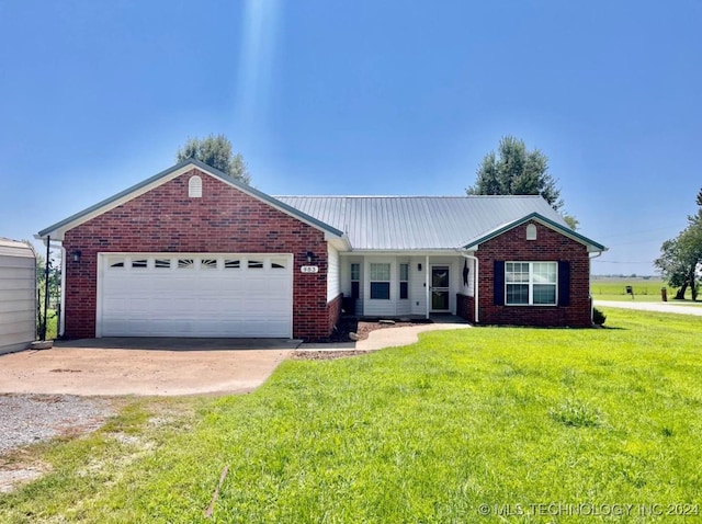 ranch-style home featuring a garage and a front yard