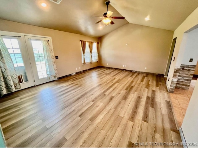 unfurnished living room featuring ceiling fan, light wood-type flooring, and vaulted ceiling