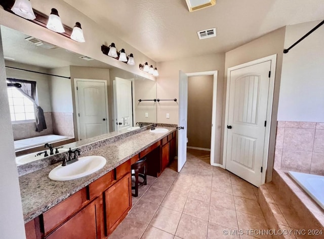 bathroom featuring tile patterned floors, vanity, a relaxing tiled tub, and toilet