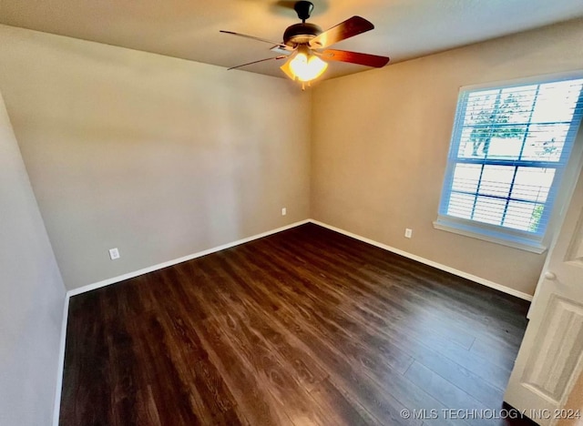 spare room with ceiling fan and dark hardwood / wood-style floors