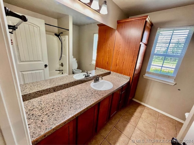 full bathroom featuring tile patterned flooring, vanity, bathtub / shower combination, and toilet