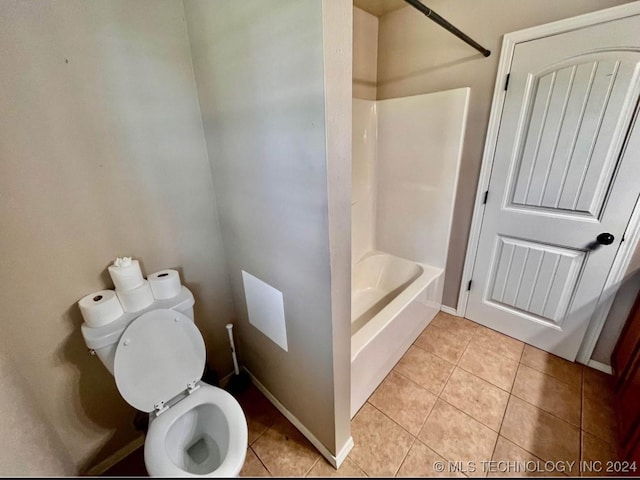 bathroom with toilet,  shower combination, and tile patterned floors