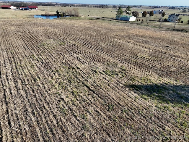 aerial view featuring a rural view and a water view