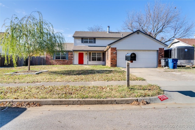 front of property featuring a garage and a front lawn