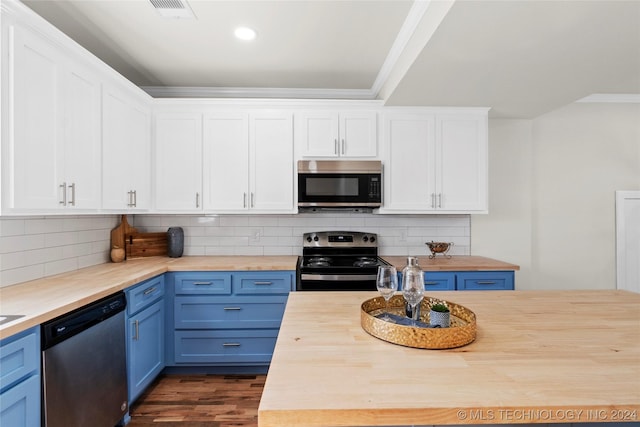 kitchen featuring backsplash, stainless steel appliances, blue cabinets, dark hardwood / wood-style floors, and butcher block counters