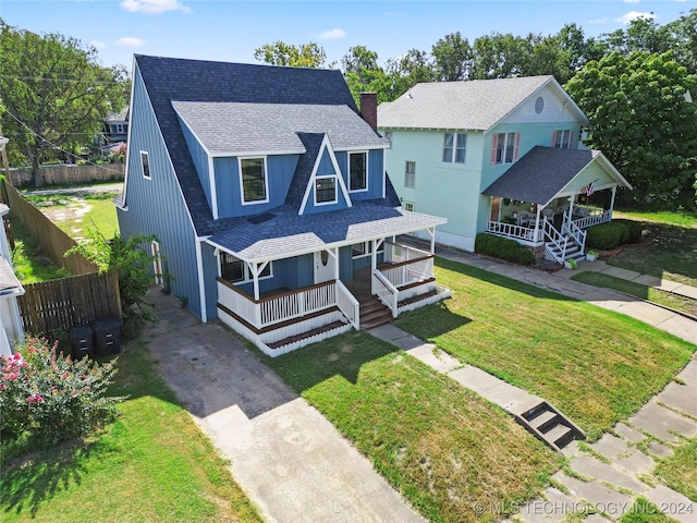 view of front facade featuring covered porch and a front lawn