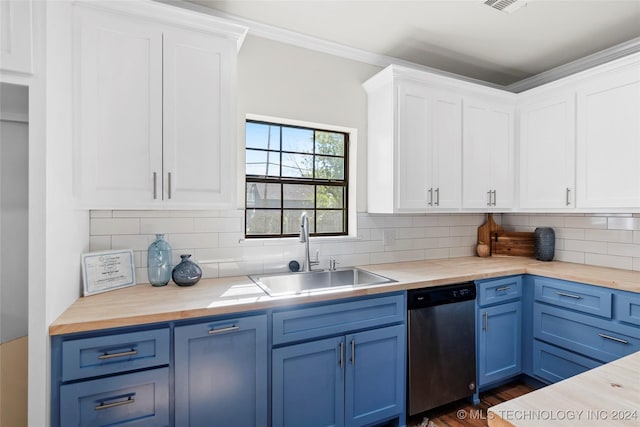 kitchen featuring stainless steel dishwasher, tasteful backsplash, sink, and wooden counters