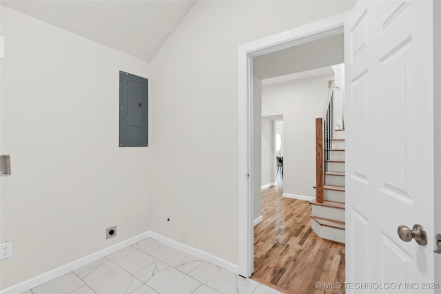 washroom featuring hookup for an electric dryer, electric panel, and light hardwood / wood-style floors