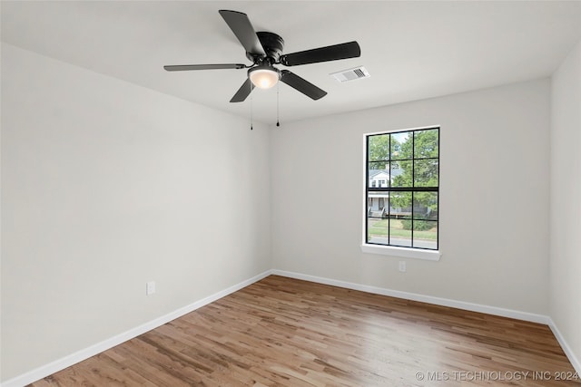 empty room with ceiling fan and light wood-type flooring