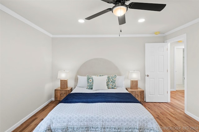 bedroom featuring hardwood / wood-style floors, ceiling fan, and ornamental molding