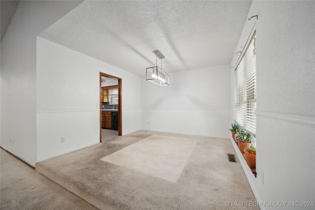 carpeted dining area featuring sink and a textured ceiling