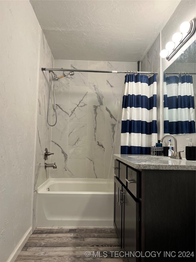 bathroom with shower / bathtub combination with curtain, vanity, a textured ceiling, and hardwood / wood-style flooring