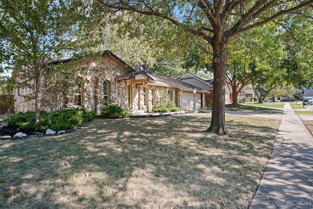 view of front of house with a front yard and a garage