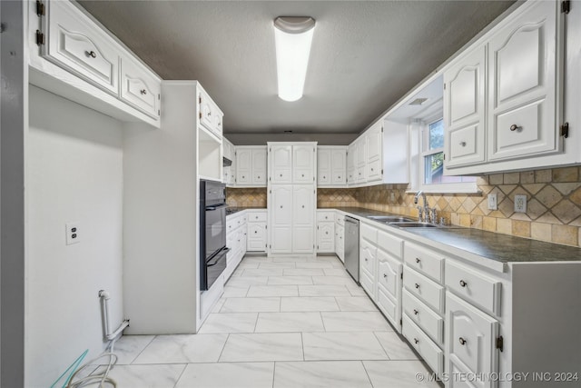 kitchen with decorative backsplash, white cabinetry, dishwasher, and sink