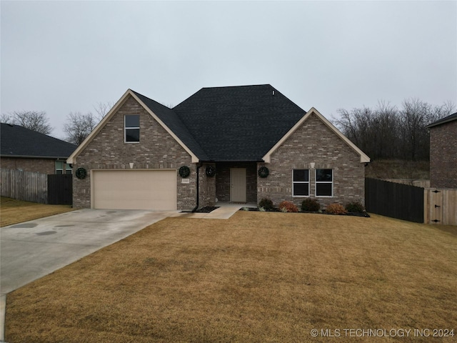 view of front of house with a front yard and a garage