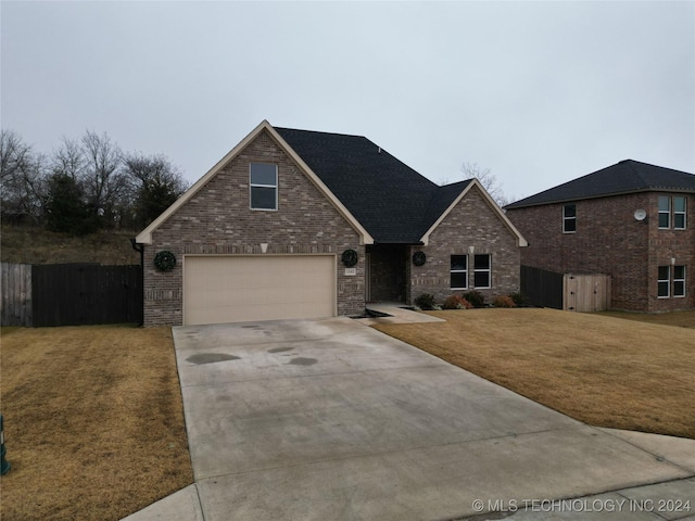 view of property with a garage and a front yard