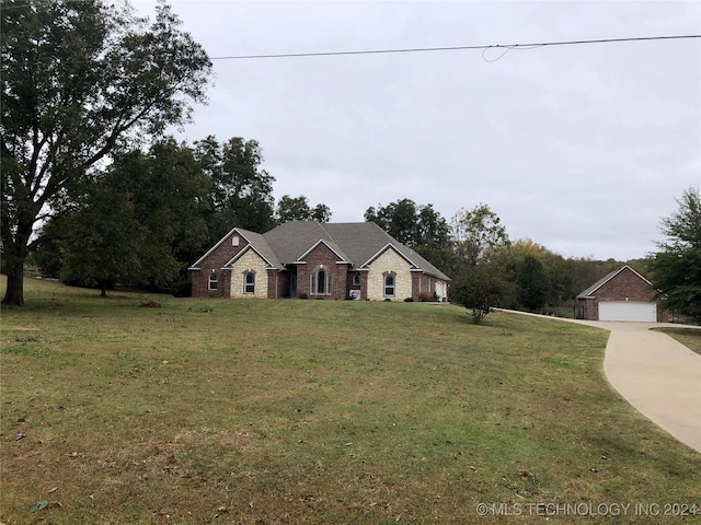 single story home featuring a garage and a front yard